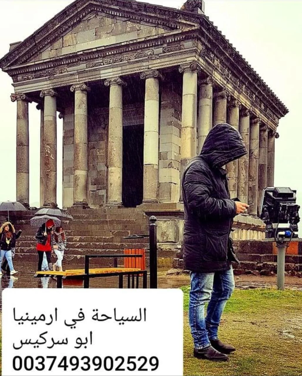 Temple of Garni in Armenia with a traveler in the foreground