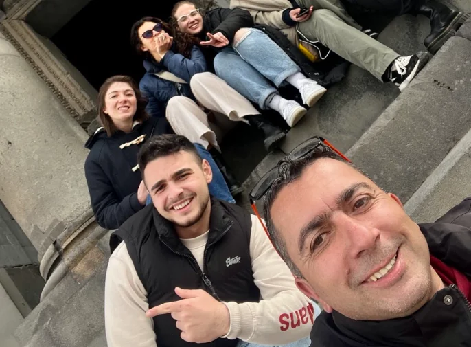 Abu Sarkis and a group of smiling travelers
