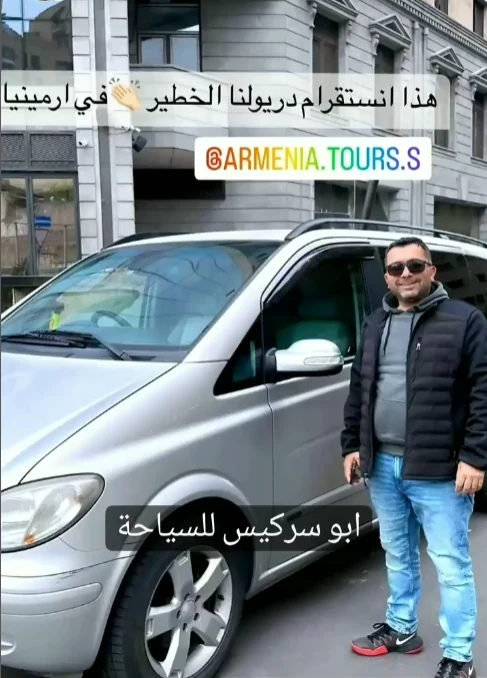 Abu Sarkis standing beside his private tour vehicle